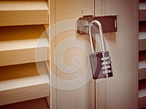 Old Padlock with key code on Wooden Gate