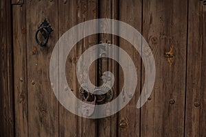 Old padlock at one wooden door