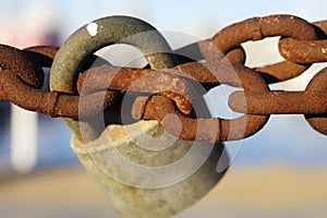 Old padlock on rusty chain