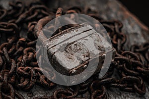 Old padlock on a rusty chain close-up. The concept of protection, safety, security