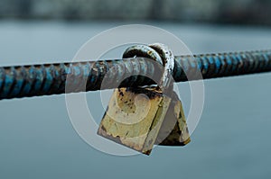 Old padlock. Vintage lock on the railing. Closed padlock. Iron fittings.