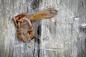 Old padlock on a wooden door