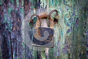 Old padlock on a wooden door