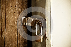 Old padlock on a wooden door