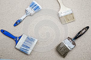 Old paint brushes. Different sizes. Top view on a dark wooden background. With blank place for text. Building. Repairs.