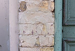 Old paint peeling bricks on a building