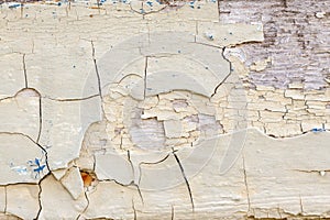 Old painted biege wall with cracks and blue inclusions photo