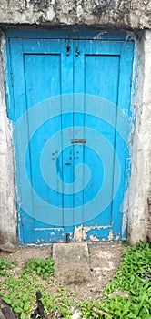 Old painted blue color backyard closed  door