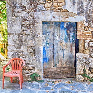 Old painted blue door on the ancient stone wall, Greece