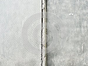 an old painted iron pipe vertically against. Abstract empty background.Photo of gray natural concrete wall texture.