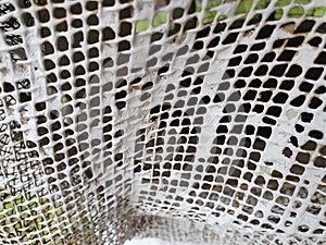 Old painted metal fencing mesh.