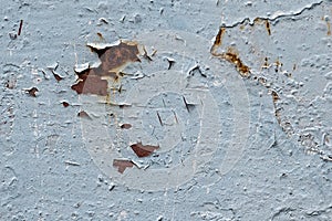 Old painted metal plate has deteriorated, has rust and cracked paint