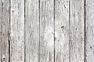 Old painted wooden texture, fence made of wooden planks. Abstract background for design. White rustic fence, peeling paint
