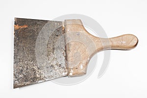Old painter`s spatula with rust with wooden handle on white background