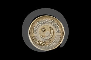 An old Pakistani two rupee coin isolated on black