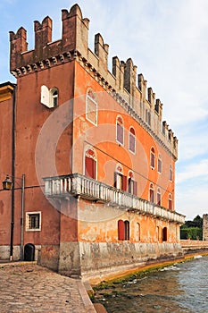 Old palazzo with swallowtail battlement in Lazise at the coast of lake Garda