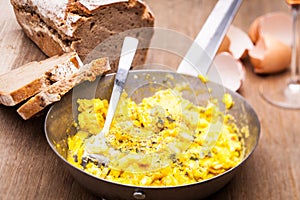 Old pan with  fresh scrambled eggs