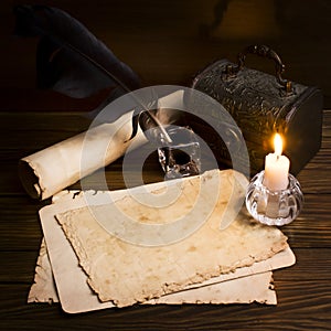 Old paper and a candle on a wooden table