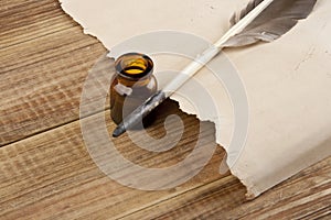 Old paper and feather with ink isolated on white