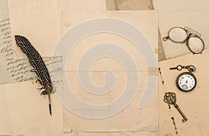 Old paper feather pen vintage accessories flat lay background