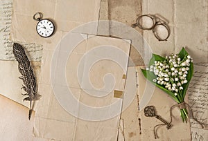 Old paper feather pen vintage accessories spring flowers Nostalgic background photo