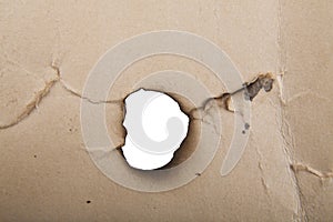 Old paper with a hole on a white background