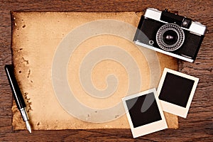 Old paper, ink pen and vintage photo frame with camera