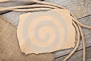 Old paper and rope on wooden textured background