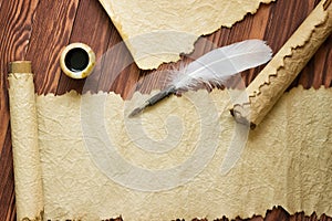 Old paper, scroll and quill pen on wooden paper with copy space