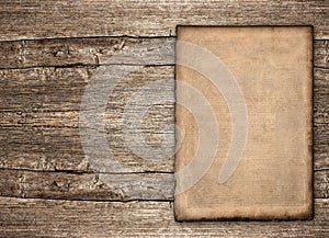 Old paper sheet over rustic wooden background