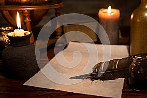 Old parchment paper with a quill and ink, medieval theme photo