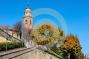 Old parish church and autumnal trees in Piedmont, Italy.