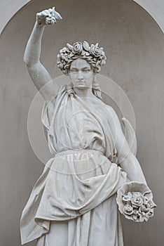 Old park statue of sensual Italian or Greek Renaissance Era woman in historical downtown city park in Potsdam, Germany