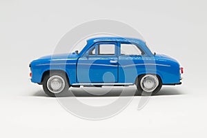 Old passenger car of blue color on a white background - car model. photo