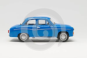 Old passenger car of blue color on a white background - car model photo