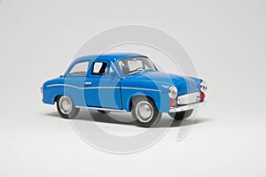 Old passenger car of blue color on a white background - car model. photo