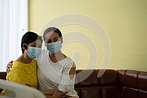 Old patient Asian woman  in hospital with daughter taking care with protective face mask.  Health care and medicine concept