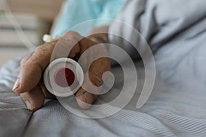 old patient hand with safety needle on back palm