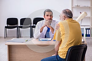 Old patient visiting young male doctor