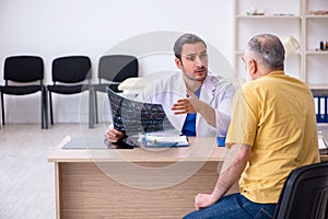 Old patient visiting young male doctor radiologist