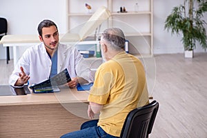 Old patient visiting young male doctor radiologist
