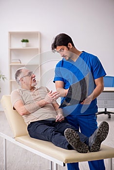 Old male patient visting young male doctor radilogist photo