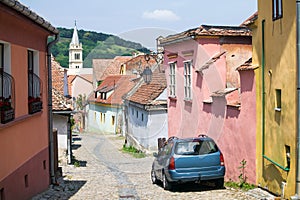 Old paved stone street with colored houses from Old Turda