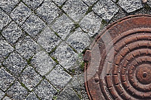 Old pavement block and manhole