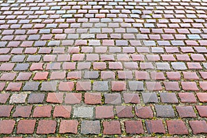 The old pavement of red granite paving stone