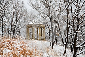 Old pavilion in a city park after heavy snowfall