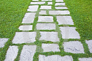 Old paving in a public park made with irregularly shaped stone blocks in a pedestrian zone