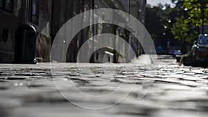 Old paving slabs with recesses between the stones, close-up, selective focus, dark tone.