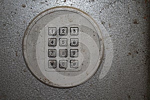 Old payphone dial with square buttons