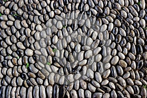 Old pebble stones road. Pebble path